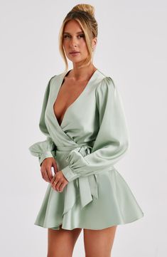 Ellis is playful, flirty and the ONLY dress to have in your wardrobe this season. With stunning sleeves that are super voluminous and a sexy plunge neckline, this wraparound style is complete with a flared skirt and looks amazing paired with knee high heeled boots. 



Colour: Sage.

Luxury non stretch satin.

Plunge neck.

Wraparound detail.

Tie belt.

Flared skirt.

Voluminous sleeves.

Mini length.

Model is an XS and is wearing an XS.

 Size: XS, S, M, L, XL, XXL