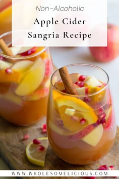 two glasses filled with apple cider sangria recipe on top of a cutting board