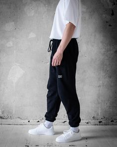 Upgrade your casual wardrobe with the Bregos Men's Black Pants. These versatile pants are perfect for any occasion, offering a blend of comfort and style. Made from 100% premium cotton, they are ultra-soft and breathable, ensuring all-day ease. The elastic waistband with an adjustable drawstring provides a secure and customizable fit. Features include side pockets and a back pocket for convenience, and ribbed cuffs for a modern look. Pre-shrunk so no surprises in the wash, and available in vario No Surprises, Black Pants Men, Comfortable Pants, Men's Sweatpants, Pants Black, Mens Sweatpants, Stylish Men, Casual Wardrobe, Effortless Style