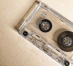 an old fashioned cassette tape recorder sitting on top of a white counter next to a pair of scissors