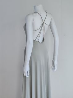 "Another perfect Giorgio Armani 90s dress! Both elegant and alluring. Giorgio Armani Spring/Summer 1996 runway maxi dress in pearl grey jersey. The dress is simple and almost austere from the front, in typical late 1990s minimalist style, but when the wearer turns around, it reveals a plunging bare back with straps crossing at the centre a bit like a spider web. The dress widens from the waist to reach a width of 1,5 meter at the hem, so it is beautifully flowing with the movement of the body. F Stretch Maxi Dress With Low Back For Evening, Summer Gala Low-back Backless Dress, Summer Gala Backless Dress With Low Back, Gray Formal Maxi Dress, Summer Evening Maxi Dress With Low Back, Stretch Maxi Dress With Low Back For Summer, Low Back Stretch Maxi Dress For Summer, Stretch Low Back Maxi Dress For Summer, Summer Backless Stretch Dress