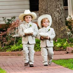 two young boys dressed in suits and hats