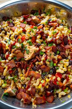 a bowl filled with pasta, meat and veggies