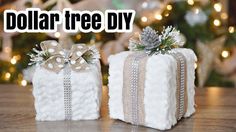 two wrapped presents sitting on top of a wooden table next to a christmas tree with the words dollar tree diy