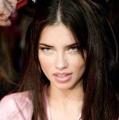 a close up of a person with long hair and wearing a tiara on her head