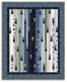 a quilted wall hanging with blue, green and white striped strips on it's sides