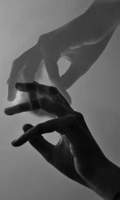 two hands reaching towards each other in the air with their fingers extended out to touch something