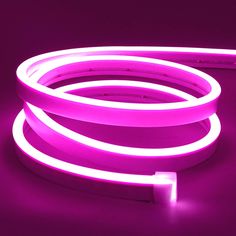 a purple neon light is lit up on a dark surface with no one around it