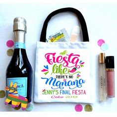 a bag with some confetti on it next to a bottle and other items