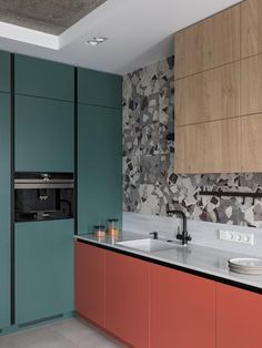 a kitchen with two sinks and an oven in the wall next to each other on top of a counter