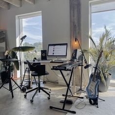 a room filled with musical equipment and windows