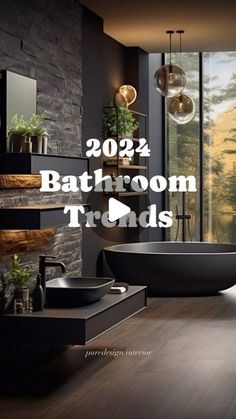 there is a bathroom with black walls and wood flooring in this photo, the bathtub has plants on it