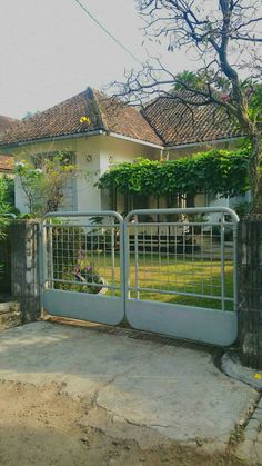 a house with a gate that is open to the yard