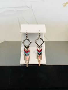 Full of color and southwestern style, these Native American-inspired dangle earrings are complete with handmade sterling silver embellishments and colorful beads.  The 5 drop bars on each earring move independently from one another. These earrings are incredibly light making them comfortable for all day wear. Native American Inspired Earrings, Glendale Az, Dragon Ring, Vintage Diamond Rings, Southwestern Style, Gorgeous Earrings, Vintage Diamond, Handmade Sterling Silver, Heart Of Gold