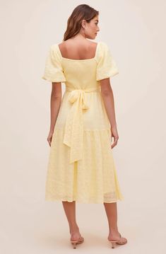 A dress that looks like a poem! The Sonnet Midi features a flattering V neckline that descends to a fitted bodice with a defined waist. Short puff sleeves and large bow accent at the back bring out the charm. Flowy midi-length skirt with a slightly ruffled trim. 100% Polyester Lining: 95% Polyester / 5% Elastane Self Tie Closure Dry Clean Only Puff Sleeve Midi Dress Back Tie Yellow Midi-length Dress With Fitted Bodice, Yellow Fitted Bodice Midi Dress, Yellow Midi Dress With Fitted Bodice, Elegant Yellow Midi Dress With Square Neck, Elegant Yellow Square Neck Midi Dress, Yellow Square Neck Midi Dress For Spring, Yellow Square Neck Dress For Daywear, Yellow Square Neck Day Dress, Yellow Casual Square Neck Dress