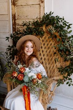 a woman sitting in a wicker chair holding a bouquet