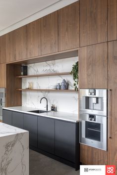 a kitchen with marble counter tops and wooden cabinets