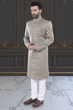 This men's Sherwani, style M42-S135, features exquisite thread embroidery and delicate sequin details. Impeccably crafted, this traditional garment offers a touch of luxury and sophistication to any occasion. Elevate your style with this stunning piece, perfect for weddings or special events. Naqshi Embroidered Straight Sherwani For Reception, Naqshi Embroidered Straight Kurta Sherwani For Reception, Naqshi Embroidered Sherwani For Reception, Long Sleeve Kurta With Naqshi For Reception, Formal Chikankari Embroidery Straight Kurta Bandhgala, Festive Long Sleeve Sherwani For Reception, Nehru Jacket With Naqshi For Reception, Straight Kurta, Nehru Jacket With Naqshi For Reception, Long Sleeve Kurta With Dabka For Reception