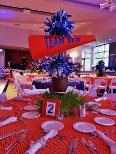 a table set up for an event with red, white and blue decorations