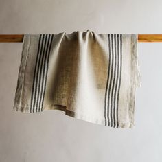 a black and white striped towel hanging on a clothes line