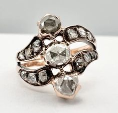 a close up of a ring with diamonds on it's sides and in the middle