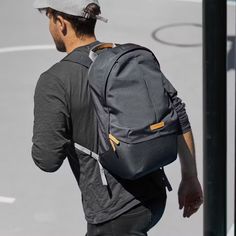 a man with a backpack is walking down the street