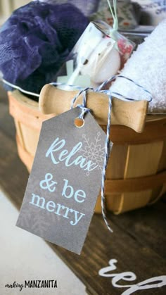 a basket filled with clothes next to a sign that says relax and be merry