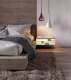 a modern bedroom with wooden headboard and white bedding, two hanging lights above the bed