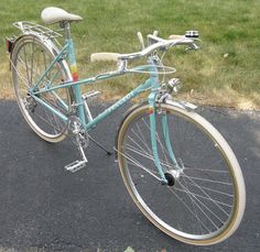 a blue bicycle parked on the side of a road