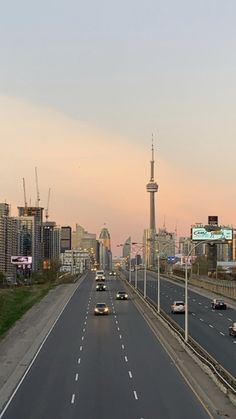 cars are driving down an empty highway in the middle of the city at sunset or dawn