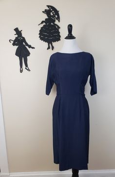 Description: 1950's absolutely stunning dark navy blue cocktail dress. Has a low rounded back and large scale fabric bow at the waist with fabric tassels hanging off each end. Sides of the waist have pleated fabric. Fabric looks like silk shantung. Measurements Bust: 30/32 inches, possibly an inch larger but hard to measure due to dollman sleeve Waist: 28 inches Length: 42 inches Size suggestion but please go by posted measurements: Small Condition: Excellent condition with no flaws to note. Lab 1950s Style Blue Formal Dress, Vintage Navy Dress For Formal Occasions, Blue Formal Dress In 1950s Style, Retro Navy Dress For Formal Occasions, Navy Retro Dress For Formal Occasions, Navy Retro Formal Dress, Navy Vintage Style Formal Dress, Blue 1950s Style Formal Dress, Formal 1950s Style Blue Dress