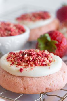 strawberry shortcakes with white frosting and sprinkles