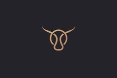 a bull's head with long horns in the middle of a black and gold background