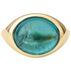 This ring features a 7.58ct oval cabochon teal tourmaline bezel set in a 14kt yellow gold ring. The ring itself is a size 6, but can be resized to be smaller or larger upon request. Luxury Gold Enamel Ring With Cabochon, Luxury Turquoise Gemstone Ring With Oval Cabochon, Luxury Enamel Cabochon Ring, Luxury Oval Cabochon Turquoise Gemstone Ring, Luxury Elegant Turquoise Oval Cabochon Ring, Luxury Turquoise Gemstone Ring, Oval Cabochon, Luxury Artisan Cabochon Rings, Luxury Adjustable Cabochon Ring, Luxury Turquoise Gemstone Ring Oval Cabochon