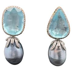 This pair of earrings showcases a stunning combination of elements that make it both fun and elegant. The 18KWG light grey baroque South Sea pearl adds a touch of sophistication, while the pear-shaped and oval aquamarines weighing approximately 32 CTS bring a pop of color and vibrancy. Mixed-color diamonds and white diamonds further enhance the overall appeal of the design. The clip-on and retractable post feature adds a practical and versatile element, ensuring that these earrings are not only stylish but also easy and comfortable to wear. Quick information: Aquamarine - Pear Shape and Oval: total weight is approximately 32.85CTS Diamonds - Round white 40 pcs. : SI2-3 K color - approximately 0.37 CTS Mixed color (yellow, brown, and pink) - SI3 - approximately 1.15 CTS Pearls: Baroque ligh Baroque Pearl And Diamond Earrings, Silver Baroque Pearl Pear-shaped Jewelry, Luxury White Baroque Pearl Earrings, Luxury Baroque Pearl Earrings With Pendant, Silver Pear-shaped Baroque Pearl Earrings, Earring Video, Cocktail Earrings, Brown And Pink, Golden South Sea Pearls