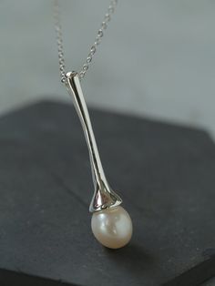 Metal: Recycled Sterling Silver Plated On Brass Pearl: Freshwater Pearls Pendant Length: 45mm Chain Length: 760-810mm Weight: 7.5g Minimalist Pearl Drop Teardrop Pendant Jewelry, Minimalist Long Pearl Pendant Necklace, Elegant Sterling Silver Pearl Necklace With Teardrop Pendant, Sterling Silver Teardrop Pearl Pendant, Teardrop Pearl Pendant In Sterling Silver, Sliver Earrings, Tiger Eye Stone, Pearl Pendant Necklace, Enamel Earrings