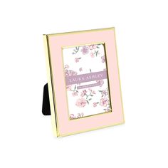 a pink and gold frame with flowers on the front is holding a card that says congratulations