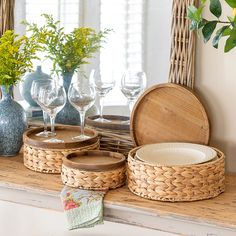 wicker baskets and wine glasses are sitting on a mantle