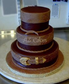 a three tiered chocolate cake on top of a counter