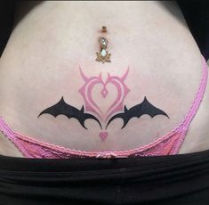 a woman's stomach with bat tattoos on her belly and the word love written in pink