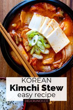 korean kimchi stew in a bowl with chopsticks and rice on the side