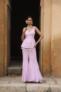 Featuring Lilac silk peplum with sequence, beads floral motif embroidery on bodice, paired with georgette inserted sharara. Fabric - Silk and Georgette Components - 2 Colour - Lilac Embroidery details - Hand Embroidery Delivery time - 2-3 weeks Washing Instructions - Dry-clean Embroidered Georgette Peplum Dress, Embellished Peplum Sets For Eid, Elegant Embellished Peplum Set, Diwali Reception Peplum Palazzo Set, Fitted Embroidered Peplum Anarkali Set, Elegant Peplum Sharara With Floral Embroidery, Embroidered Peplum Anarkali Set For Wedding, Elegant Floral Embroidered Sharara With Peplum, Fitted Embellished Peplum Palazzo Set