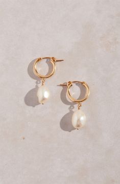 Keshi pearls dangling from high-shine hoops make a chic, modern accessory that goes with almost anything. 1 1/4" drop; 3/8" width Pearl size: 9mm Snap-post closure Due to natural variation, pearl shape and size may vary slightly 14k-gold fill/freshwater keshi pearl Made in the USA Pearl Wedding Jewelry Sets, Keshi Pearl Earrings, Playful Jewelry, Bridesmaid Pearl Earrings, Peacock Pearls, Double Earrings, Freshwater Pearl Jewelry, Pearl Jewelry Wedding, Fashion Scarves