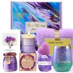 the contents of a bath gift set including candles, soaps, and other items