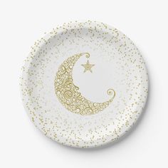 a white plate with gold stars and a crescent on it