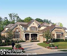 a large house with lots of windows and landscaping