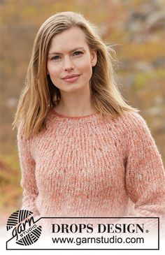 a woman in an orange sweater posing for the camera with her hands on her hips