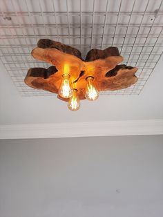 a ceiling light made out of wood and some lights on top of the wooden planks