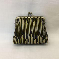 "This bright and elegant change purse is designed in gold metallic bars on a black background. Item can also be used as a small cosmetics bag, key holder, medication pouch, credit card holder, or an organizer for any small items in your handbag. Square shaped bag has a gold filigree metal purse frame with a ball clasp closure. Purse frame is sewn in with clear nylon fishing line to form invisible stitching on the outside. Outside fabric is cotton print, lining is solid black cotton fabric and it Gold Bar Design, Mini Cosmetics, Organizer Purse, Metal Purse, Fabric Purse, Purse Frame, Purse Organizer, Small Cosmetic Bags, Fabric Purses