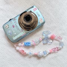 a camera and some beads on a table